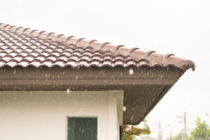 close up of IL home with hail damaged roof during a hail storm